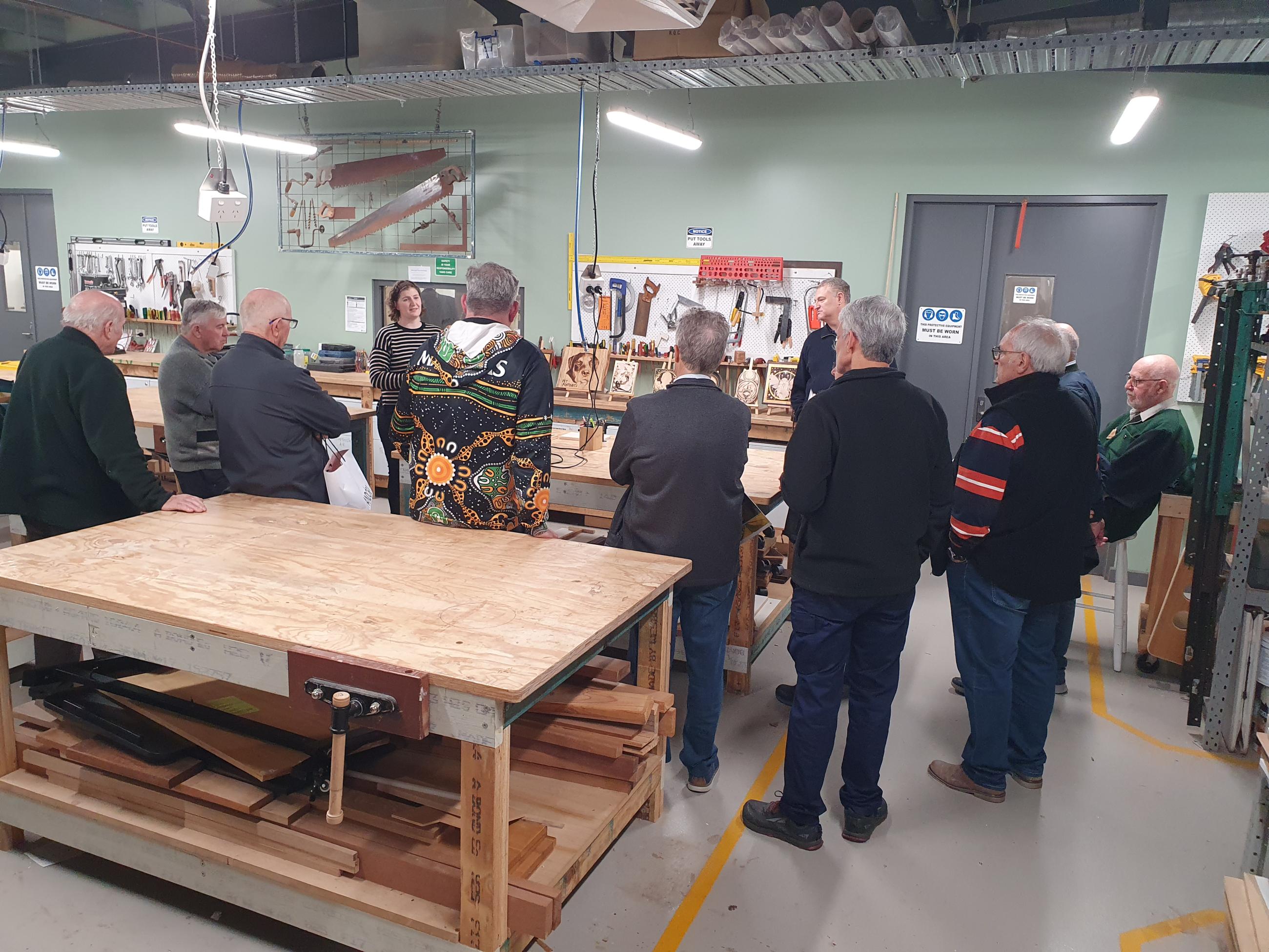 A group of people around a workbench.