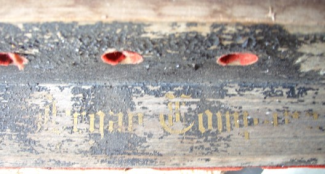 Closeup of the stop board showing how badly faded the gold lettering has become over time